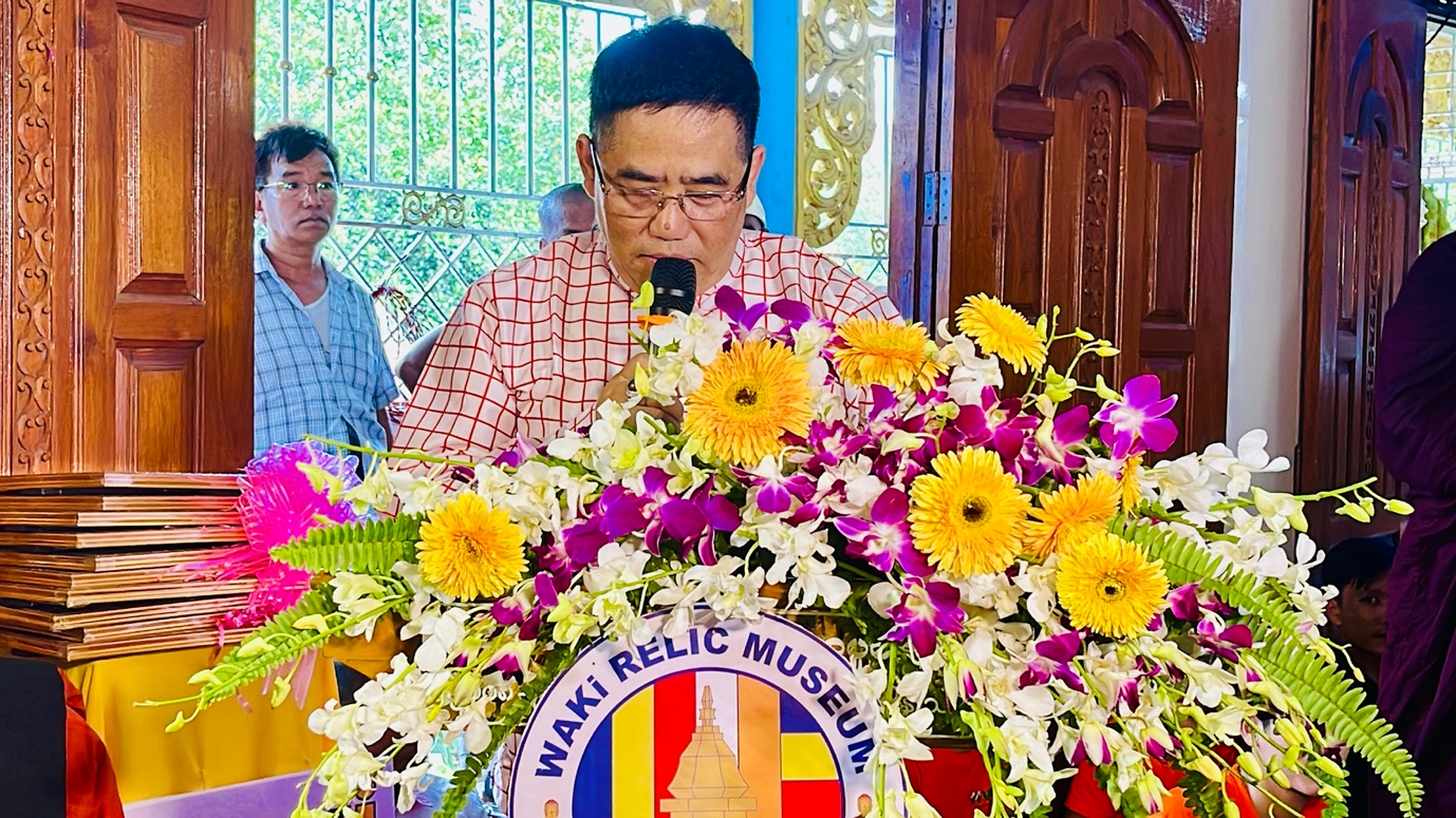 A person speaking into a microphone
Description automatically generated